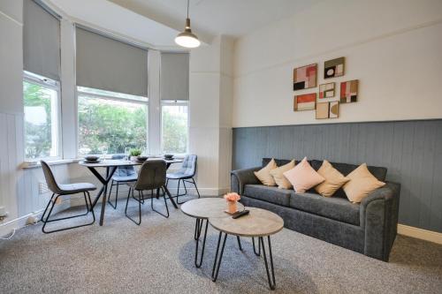 a living room with a couch and a table at Beautiful Stylish 2BD Flat - Free Parking 30 Percent Off Long term bookings in Wallasey