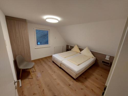 a small bedroom with a bed and a window at Haus an der Haslach in Lenzkirch