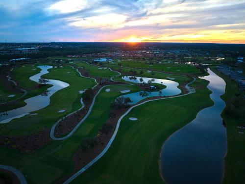 an aerial view of the golf course at sunset at Sunseeker Resort Florida Gulf Coast, Curio Collection Hilton in Port Charlotte