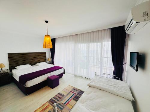 A bed or beds in a room at Fuda Hotel