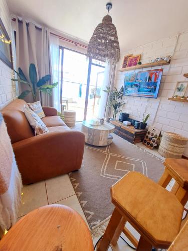 a living room with a couch and a table at La Marina home in Concón