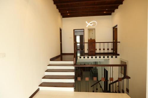 a staircase in a building with a stair case at Eden Gardens Residence in Hokandara South