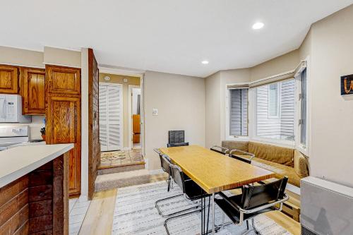 a kitchen and dining room with a table and chairs at Forest Hideaway in Waterville Valley