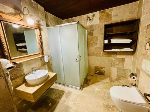 a bathroom with a sink and a toilet at Sofa Hotel in Avanos