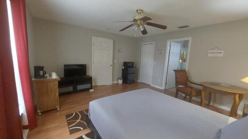 1 dormitorio con 1 cama y ventilador de techo en Close to beach, en Fort Pierce