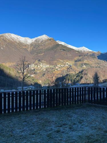 a fence in front of a mountain with snow at CASA VACANZE OLTRE IL COLLE BBQUEEN in Oltre il Colle
