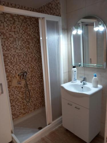 y baño con ducha, lavabo y espejo. en Apartamento Voramar Primera Linea de Mar, en El Campello