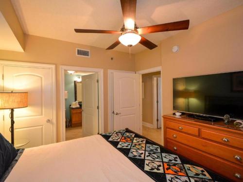 a bedroom with a bed and a flat screen tv at Azure #610 - Jack's Beach House - Top Floor Luxury in Fort Walton Beach