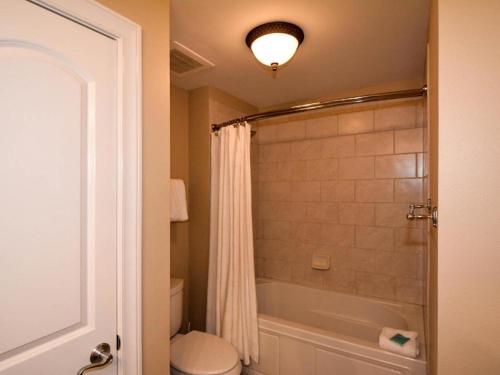 a bathroom with a tub and a toilet and a shower at Azure #610 - Jack's Beach House - Top Floor Luxury in Fort Walton Beach
