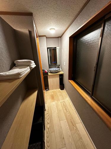 a room with a hallway with a door and a mirror at AYA-KAMOJIMA in Yoshinogawa