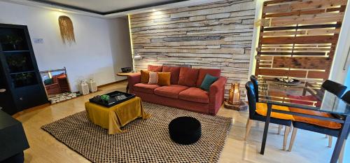 a living room with a couch and a table at epicenter LAGOA in Lagoa