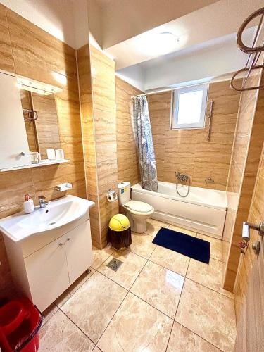 a bathroom with a sink and a tub and a toilet at Summerland Seaview Apartments in Mamaia