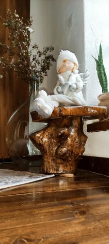 a small angel figurine sitting on a table next to a vase at Stara hiža in Lanišće