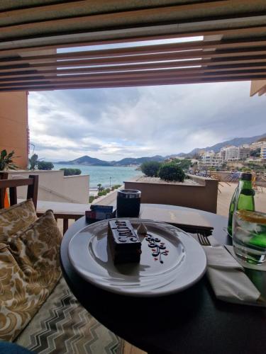 a plate with a piece of cake on a table at Apartmani Vila Marija in Budva
