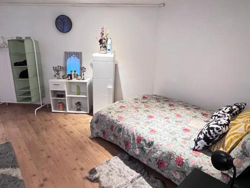 a bedroom with a bed and a dresser at Cozy Flat near Maastricht Heerlen Aachen in Übach-Palenberg