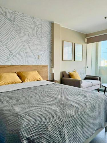 a bedroom with a large bed and a couch at Almar Punta Hermosa in Punta Hermosa