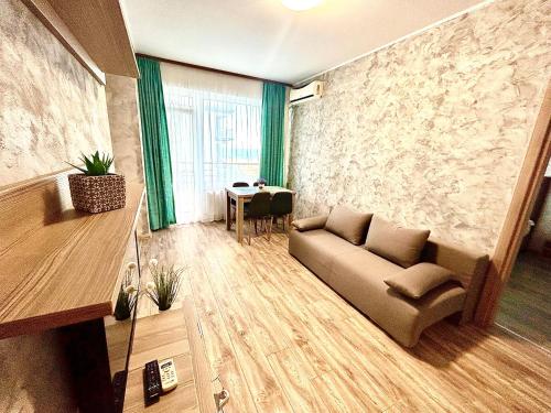 a living room with a couch and a table at Summerland Seaview Apartments in Mamaia