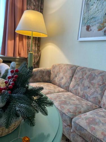 a living room with a christmas tree on a table at Natsionalny Hotel in Kyiv