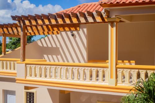 a balcony of a house with a wooden roof at Diosamar Hotel y Suites in El Valle
