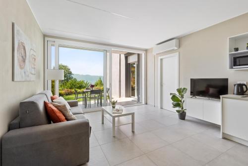 a living room with a couch and a television at Residence Conca Verde 1 with pool in Trarego Viggiona