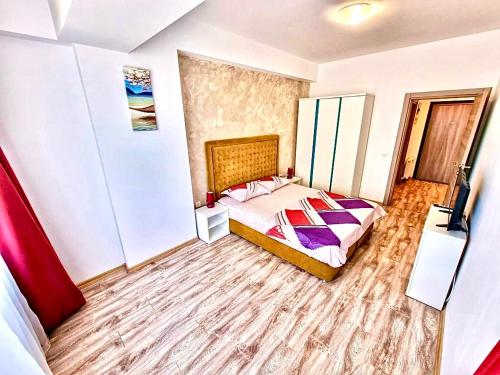 a bedroom with a bed and a television in it at Summerland Seaview Apartments in Mamaia