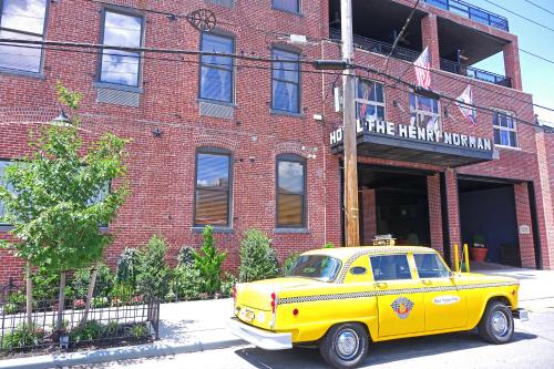 a yellow truck parked in front of a brick building at Henry Norman Hotel in Brooklyn