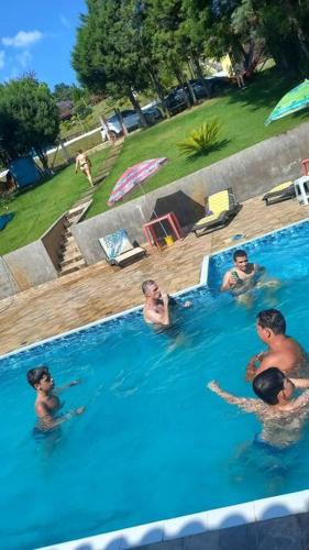 a group of people in a swimming pool at Chacara Condomínio Monte Verde Itu in Itu