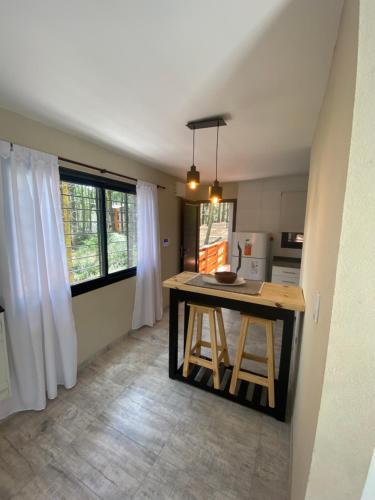 a kitchen with a table in the middle of a room at Bosque Libertad Loft in Mar Azul