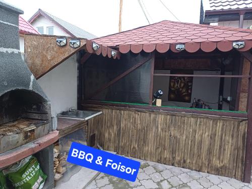 a house with a sign that says bbq and fogi at Casa KariAna in Năvodari