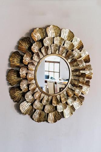 a gold mirror hanging on a wall at Kaya Residence Kandy in Kandy