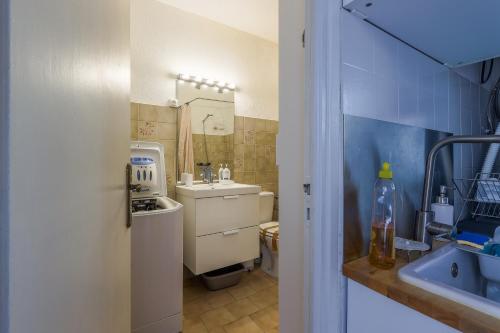 a small bathroom with a sink and a toilet at Di Mezzu - Proche plage et vue montagnes in Corbara