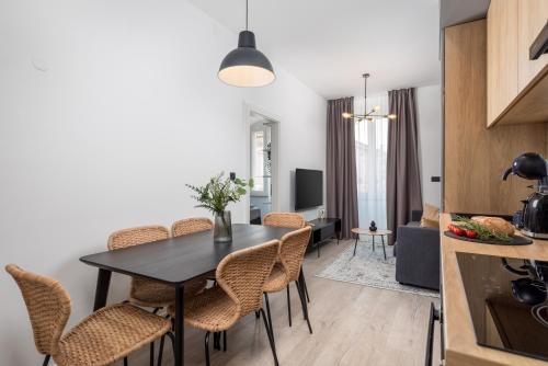 a kitchen and dining room with a table and chairs at Molo Longo - Downtown Apartments in Rijeka