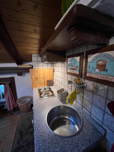 a kitchen counter with a sink in a kitchen at Mansarda in centro in Roccaraso