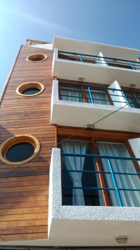 a tall building with windows on the side of it at Hotel Esmeralda in Iquique