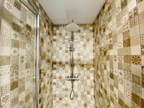 a shower with a shower head in a bathroom at Apartamento HC13 - PUERTA PURCHENA in Almería