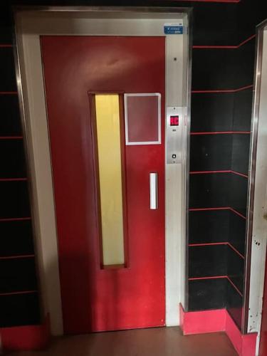 a red and yellow door in a room at Grand studio aménagé en T2 in Paris