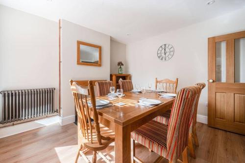 a dining room with a wooden table and chairs at Host & Stay - Sherrington Road Abode in Ipswich
