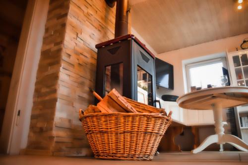 a basket of bread is next to a fireplace at Ferienwohnung zur Steinklamm im bayrischen Wald in Spiegelau