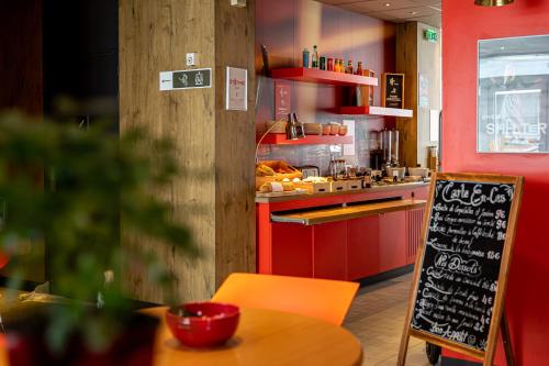 a fast food restaurant with a chalkboard in a kitchen at ibis Paris Boulogne Billancourt in Boulogne-Billancourt