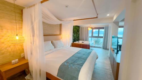 Catalina Hotel في أوباتوبا: غرفة نوم بسرير كبير ونافذة