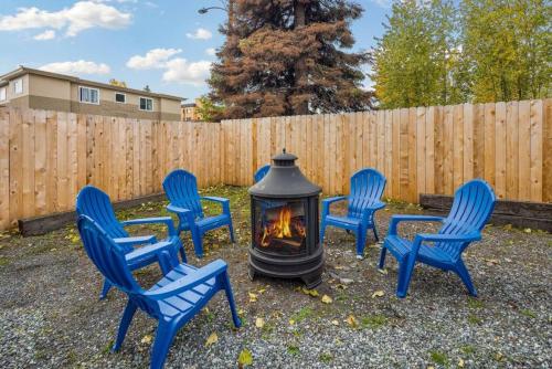 a group of blue chairs around a fire pit at Cozy Little Cabin Slumber Village 3 in Anchorage