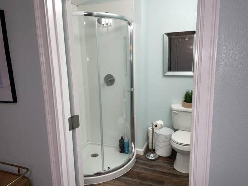 a bathroom with a shower and a toilet at Cozy Little Cabin Slumber Village 3 in Anchorage