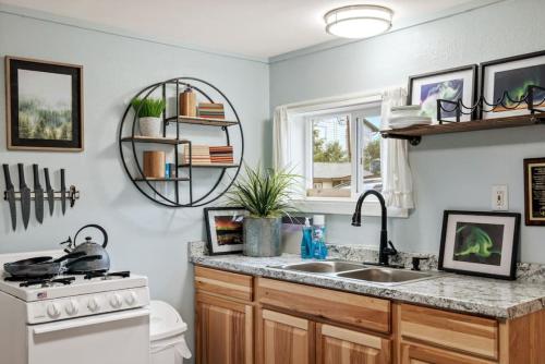 a kitchen with a sink and a counter top at Pendleton Cottage Slumber Village 1 in Anchorage