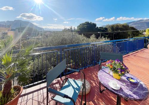 a balcony with a table and chairs on a deck at Solemar Sicilia - Villa Mariù in Palermo