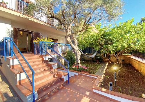 a set of stairs leading to a house with a tree at Solemar Sicilia - Villa Mariù in Palermo