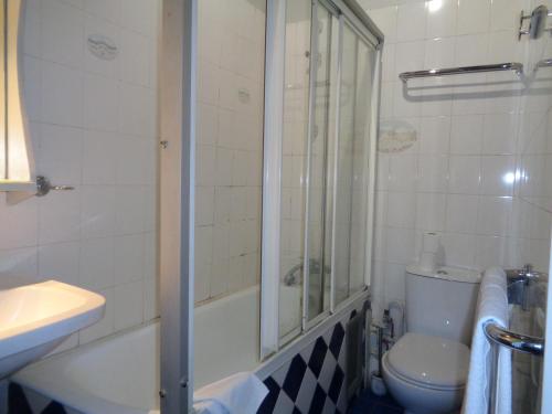 a bathroom with a shower and a toilet and a sink at Hôtel les Degrés de Notre Dame in Paris