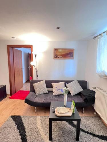 a living room with a couch and a table at Cozy Flat near Maastricht Heerlen Aachen in Übach-Palenberg