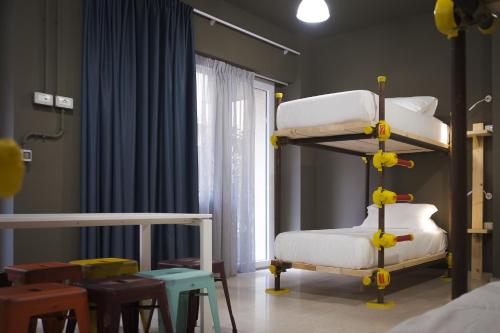 a room with two bunk beds and a window at Hostelò - Luxury Hostel in Palermo