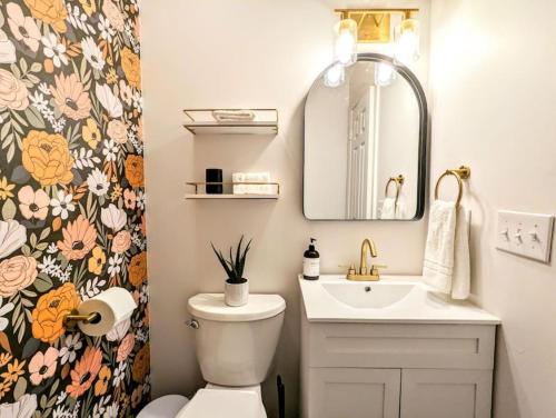 a bathroom with a sink and a toilet and a mirror at Bohemian Tiny Home - Walk to Starbucks in Taylors