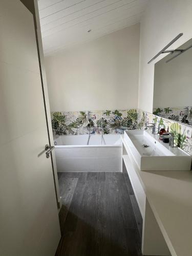 une salle de bain avec deux lavabos et une baignoire dans l'établissement La villa Bremaudières - Villa pour 14 personnes avec Piscine à 150m de la mer, au Bois-Plage-en-Ré